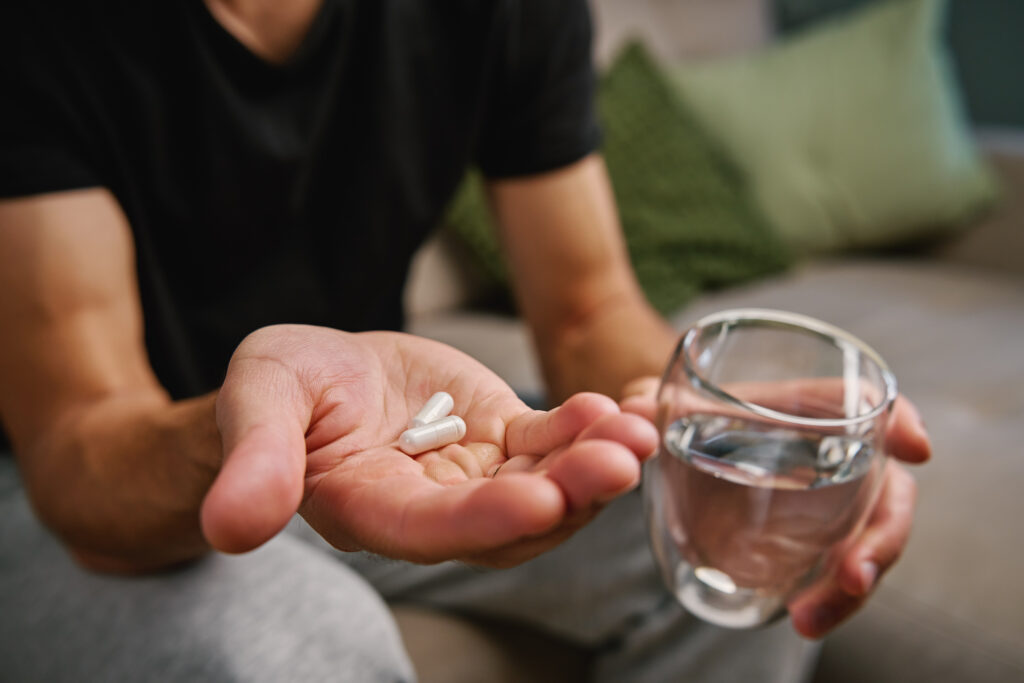 Man taking male pattern baldness prevention medication